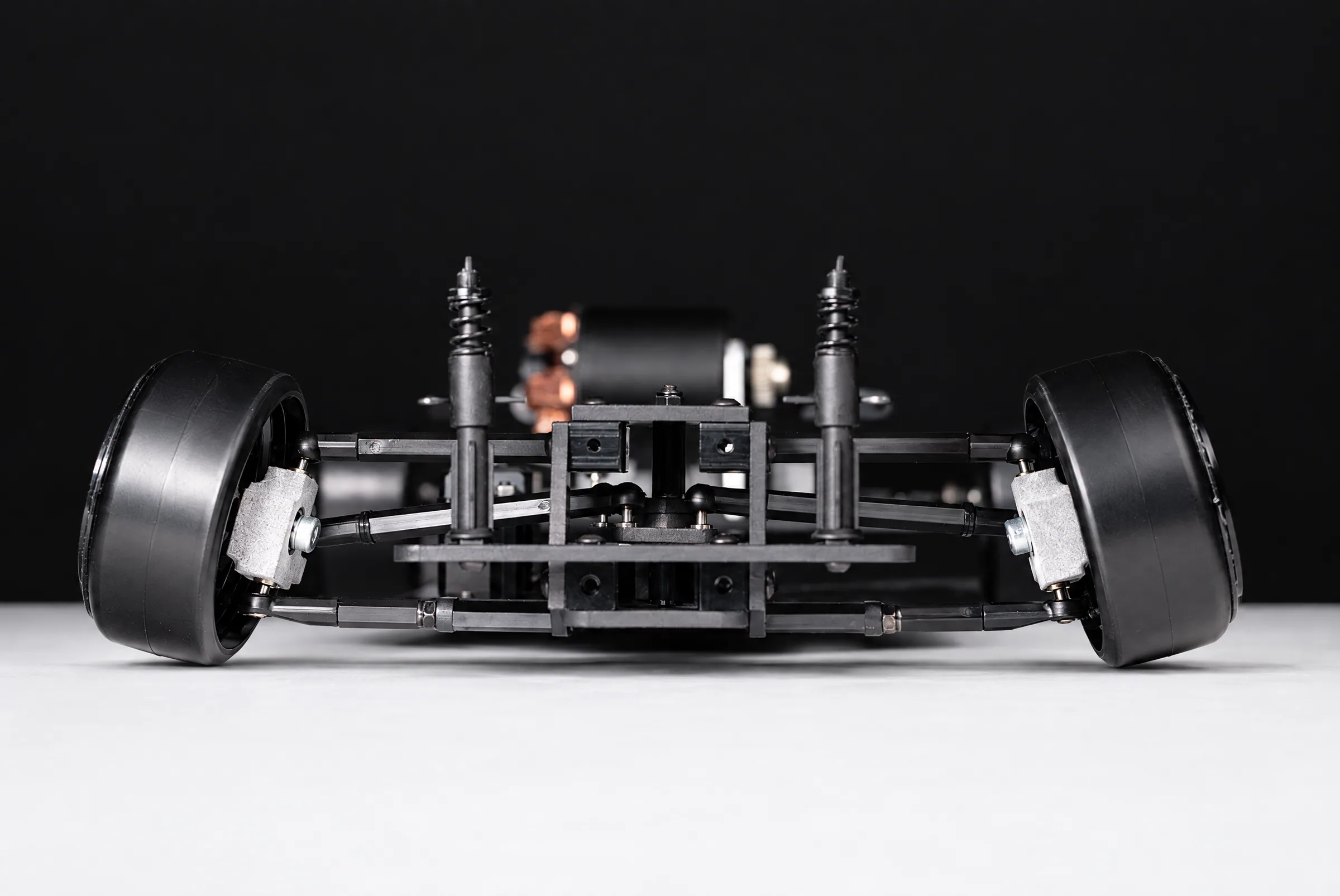 The V0 head-on at floor level, showing the front arms, knuckles and steering